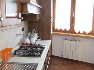 a kitchen with a stove top oven next to a window at Chiara B&b in Trieste