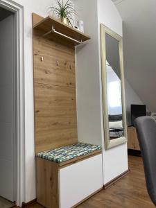 a dressing room with a mirror and a bench at APARTMAN PAVIĆ in Vinkovci