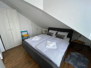 a bedroom with a bed in a attic at APARTMAN PAVIĆ in Vinkovci