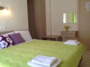 A bed or beds in a room at Angelica Studios and Apartments