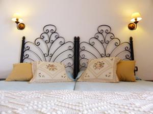 a bedroom with a white bed with two pillows at Hotel Rural El Navío - Adults Only in Alcalá