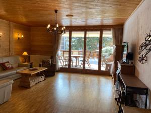 a living room with a couch and a table at Apartment La Berciére 6 in Villars-sur-Ollon