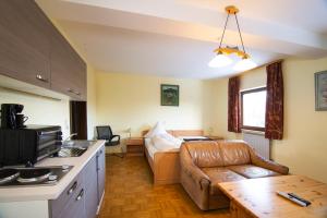 a kitchen and a living room with a couch and a table at Zum Bergischen Hof in Dormagen