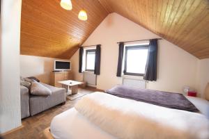 a bedroom with a bed and a couch in a room at Zum Bergischen Hof in Dormagen +21 photos