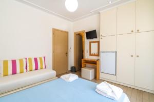 a living room with a couch and a kitchen at Alisahni studios in Nikiana