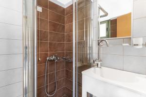 a bathroom with a shower and a sink at Alisahni studios in Nikiana