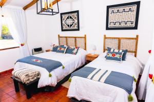 a bedroom with two beds and a window at ESTANCIA LOS CUARTOS in Tafí del Valle