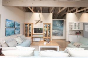 a living room with a couch and a table at Kamma-Otter in Natureʼs Valley