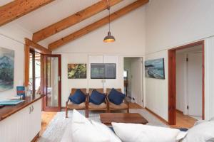 a living room with a couch and a table at Kamma-Otter in Natureʼs Valley