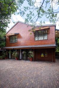 a house with a brick driveway in front of it at Kamma-Otter in Natureʼs Valley