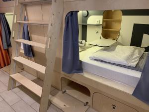a room with two bunk beds and a mirror at Kino Hostel on Pushkinskaya in Saint Petersburg