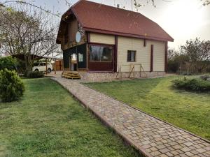 a house with a brick path in front of it at Two Floors House on Chernomorskaya in Bolʼshaya Balabanka