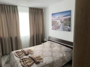 a bedroom with a bed and a picture on the wall at Welcome home in Stara Zagora