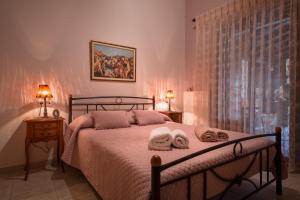 a bedroom with a bed with two towels on it at Villa Begonia by the sea in Koropi