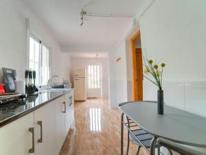 a kitchen with a table and a dining room at Tranquil Holiday Home in Albox with shared pool in Albox