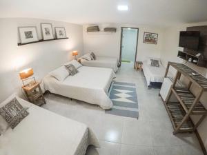 a living room with two beds and a couch at Pousada Nova Gironda in Paty do Alferes +79 photos