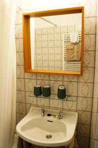 a bathroom with a sink and a mirror at Studio zee in Nieuwpoort