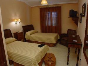 Posteľ alebo postele v izbe v ubytovaní Hostal Emilia