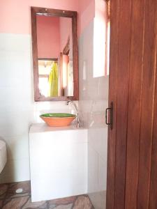 a bathroom with a sink and a mirror at Posada El Artesano De Raquira in Ráquira