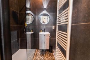 a bathroom with a tub and a toilet and a sink at Luxury Suites Boutique in Antwerp
