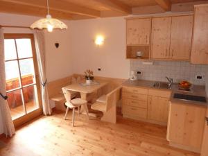 a kitchen with a table and a dining room at Kerschbaumhof in San Candido