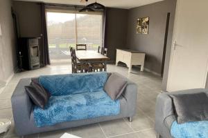 a living room with a couch and a table at Maison de vacances - Lac de Chaumeçon - Morvan - La Méloise in Saint-Martin-du-Puy