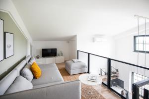 a living room with a couch and a tv at Apart Hüsske 1 in Krefeld