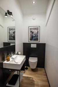 a bathroom with a white toilet and a sink at Apart Hüsske 1 in Krefeld