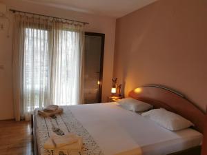 a bedroom with a large bed with two towels on it at Guesthouse Vukasevic in Virpazar