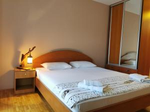 a bedroom with a bed with towels on it at Guesthouse Vukasevic in Virpazar