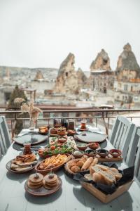 a table topped with lots of plates of food at Mia Cappadocia Cave Hotel in Göreme