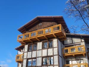 a house with wooden balconies on top of it at Na górze 23 in Szklarska Poręba