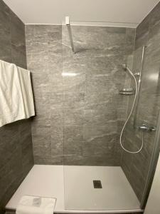 een badkamer met een glazen douche en een toilet bij Hotel Casino in Sierre