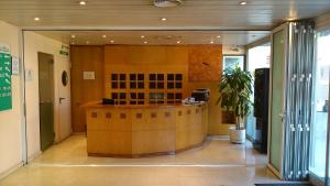 a lobby with a reception desk in a building at Hotel Montmeló in Montmeló