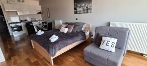 a living room with a bed and a couch at Studio apartman Anamaria in Zagreb