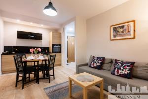 a living room with a couch and a table at JM Millennium Port in Warsaw