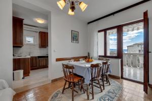 a kitchen and dining room with a table and chairs at Apartments Tihomir Mušac in Omiš