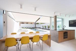 a kitchen and dining room with a table and yellow chairs at Remote workers paradise@the Atlantic in Candelaria
