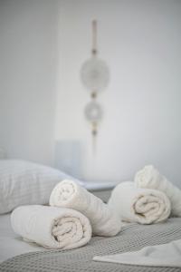 a pile of towels sitting on top of a bed at Aelia Sea View Studios in Afitos +186 photos