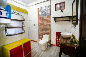 a small bathroom with a toilet and a sink at Majikal B&B - Santa Clara in Cholula +19 photos