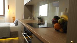 a kitchen with a bowl of fruit on a counter at Seasons Sunrise Studio - nature & view in Braşov +28 photos