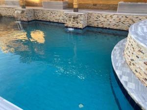 a swimming pool with blue water at Geo Palace in Dahab