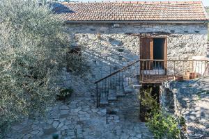 a stone house with a staircase leading to a door at To Konatzi tou Flokka in Ayios Theodhoros