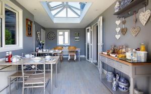 a kitchen with a table and a dining room at Lawson Cottage B&B in Hickling
