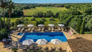 an aerial view of a swimming pool with umbrellas at Agroturismo S Hort de Can Carrio AG226 in Ses Salines