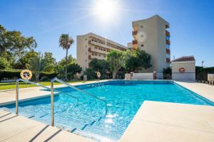 a swimming pool in front of a building at Paraiso del Sol II in Benajarafe