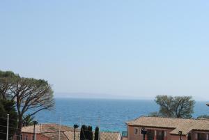 a view of the ocean from a house at Cap Nègre Hôtel in Le Lavandou