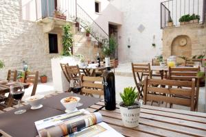 a table with a bottle of wine sitting on a patio at Residence San Martino - Rooms & Suite Apartments in Erice