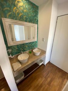 a bathroom with two sinks and a large mirror at Vittorio 55 in La Plata +3 photos