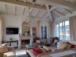a living room with a couch and a fireplace at Villa la provenzale in Camaiore